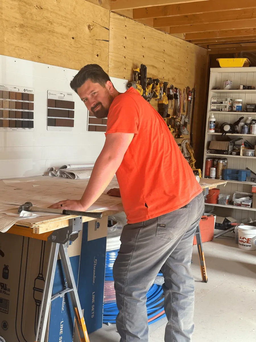 Joaquin Harris, owner of Level Craft Construction, reviewing plans in the shop